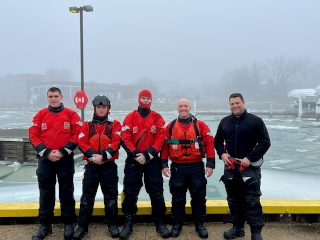 Coast Guardsmen posed for a photo after rescuing the dog.