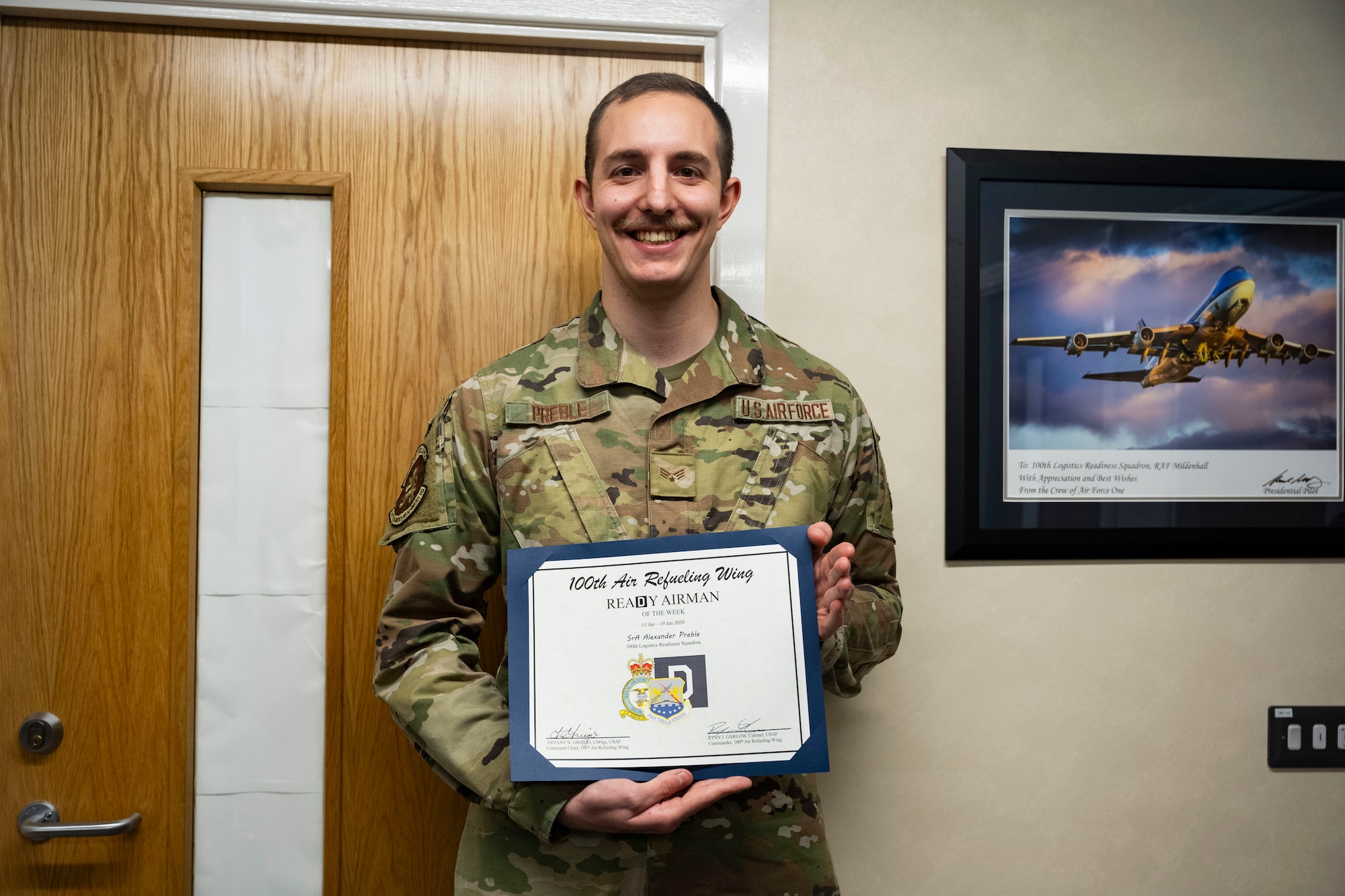 U.S. Air Force Senior Airman Alexander Preble, 100th Logistics Readiness Squadron fuels distribution operator, holds a certificate of recognition from the 100th Air Refueling Wing command team for being the ReaDy Airman of the Week at Royal Air Force Mildenhall, England, Jan. 25, 2024.