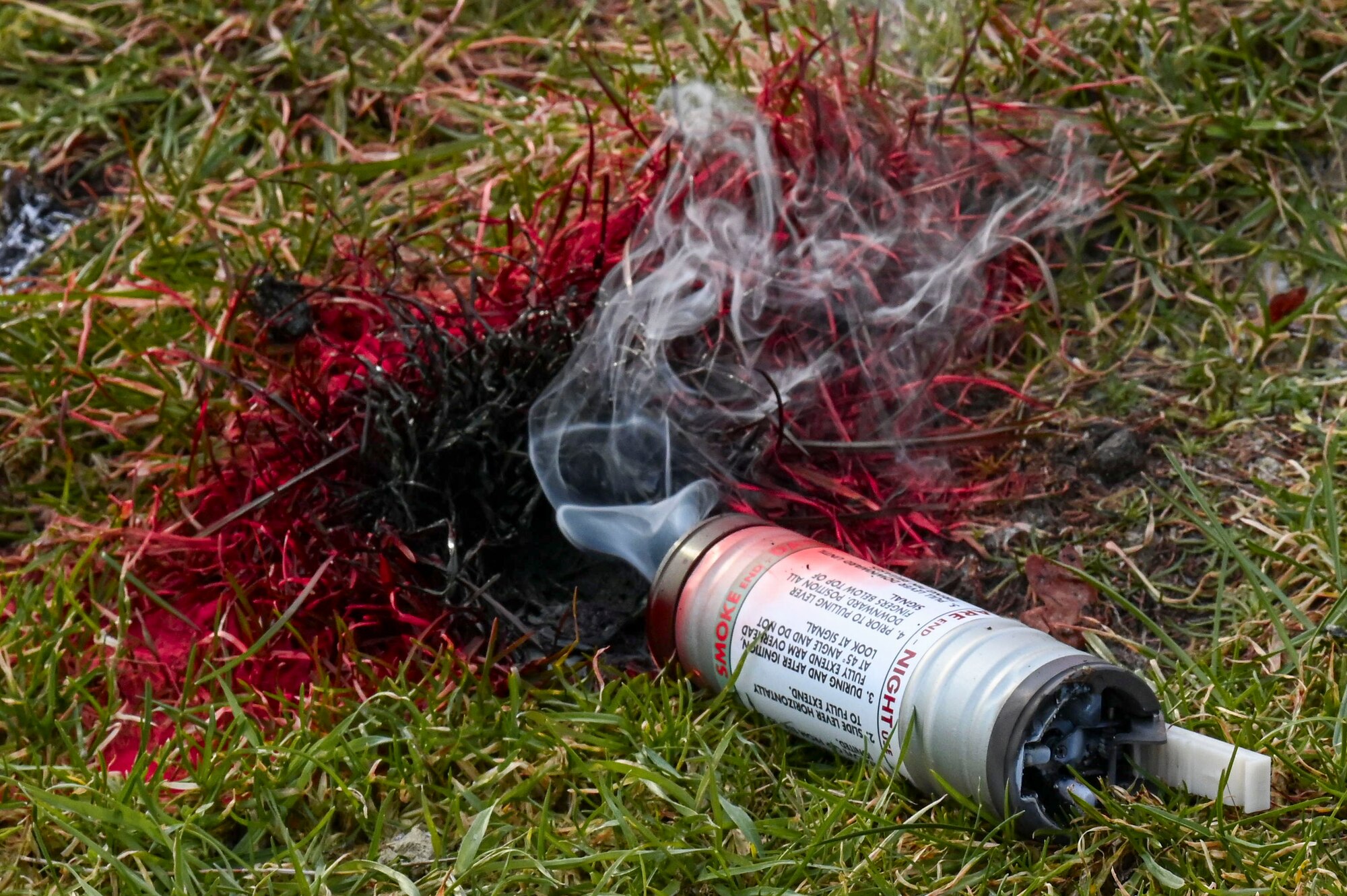 U.S. Airmen assigned to the 352nd Special Operations Wing released smoke grenades to practice signalling survival, evasion, resistance and escape instructors in case of emergencies during combat survival training.