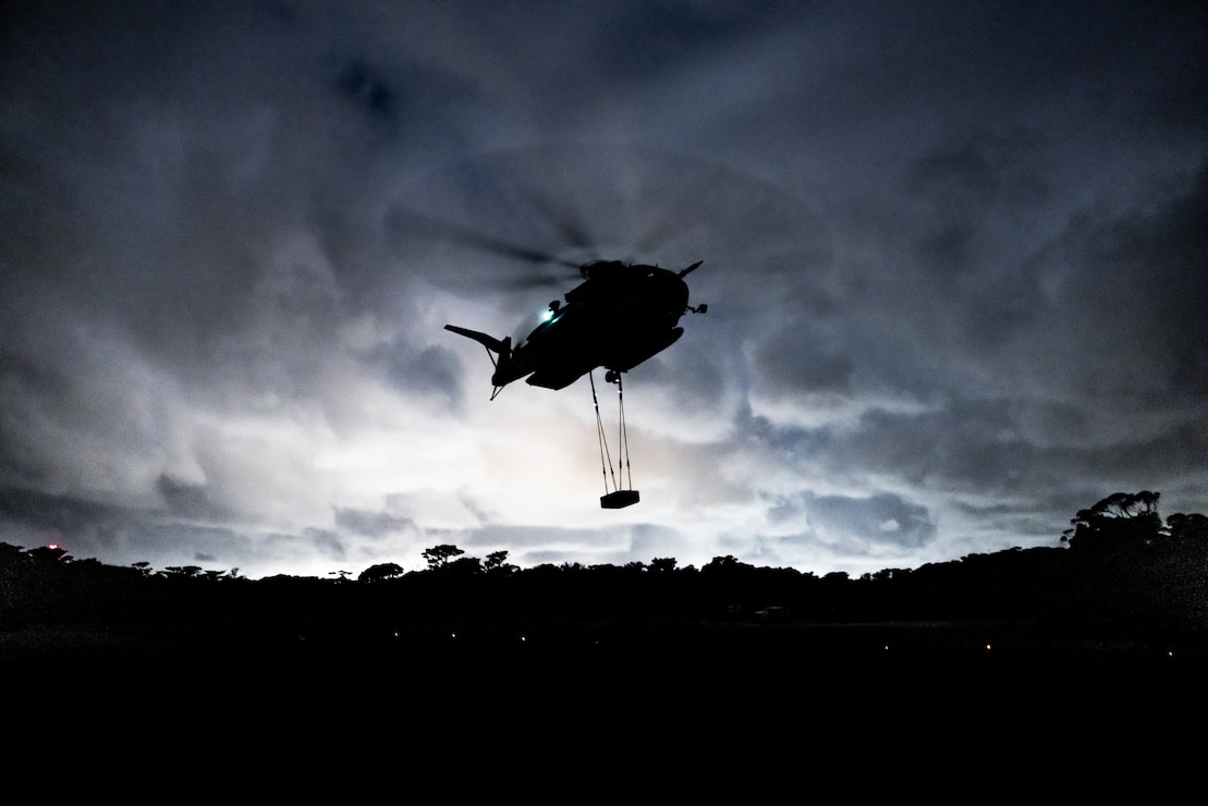 A U.S. Marine Corps CH-53E Super Stallion assigned to Marine Heavy Helicopter Squadron 466, 1st Marine Aircraft Wing, lifts a pallet during helicopter support team training at Landing Zone Dodo, Camp Hansen, Okinawa, Japan, Jan. 25, 2024. The training rehearsed sustaining the ground combat element within an Alert Contingency Marine Air-Ground Task Force, and enhanced the Marines' ability to conduct expeditious transport and versatility in support of expeditionary advanced base operations.