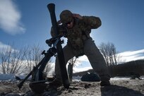 Spc. Emilio Bailey, an indirect fire infantryman with Headquarters and Headquarters Company, 1st Battalion, 125th Infantry Regiment, Michigan Army National Guard, signals to others in his unit while repositioning an 81mm mortar during exercise Northern Strike 24-1 at Camp Grayling Maneuver Training Center, Michigan, Jan. 21, 2024. Northern Strike 24-1 is the winter warfare component of the annual National Guard Bureau-sponsored Northern Strike exercise series.