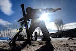 Spc. Emilio Bailey, an indirect fire infantryman with Headquarters and Headquarters Company, 1st Battalion, 125th Infantry Regiment, Michigan Army National Guard, signals to others in his unit while sighting in an 81 mm mortar during exercise Northern Strike 24-1 at Camp Grayling Maneuver Training Center, Michigan, Jan. 21, 2024. Northern Strike 24-1 is the winter warfare component of the annual National Guard Bureau-sponsored Northern Strike exercise series.