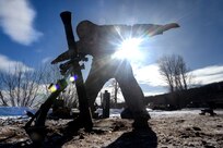 Spc. Emilio Bailey, an indirect fire infantryman with Headquarters and Headquarters Company, 1st Battalion, 125th Infantry Regiment, Michigan Army National Guard, signals to others in his unit while sighting in an 81 mm mortar during exercise Northern Strike 24-1 at Camp Grayling Maneuver Training Center, Michigan, Jan. 21, 2024. Northern Strike 24-1 is the winter warfare component of the annual National Guard Bureau-sponsored Northern Strike exercise series.