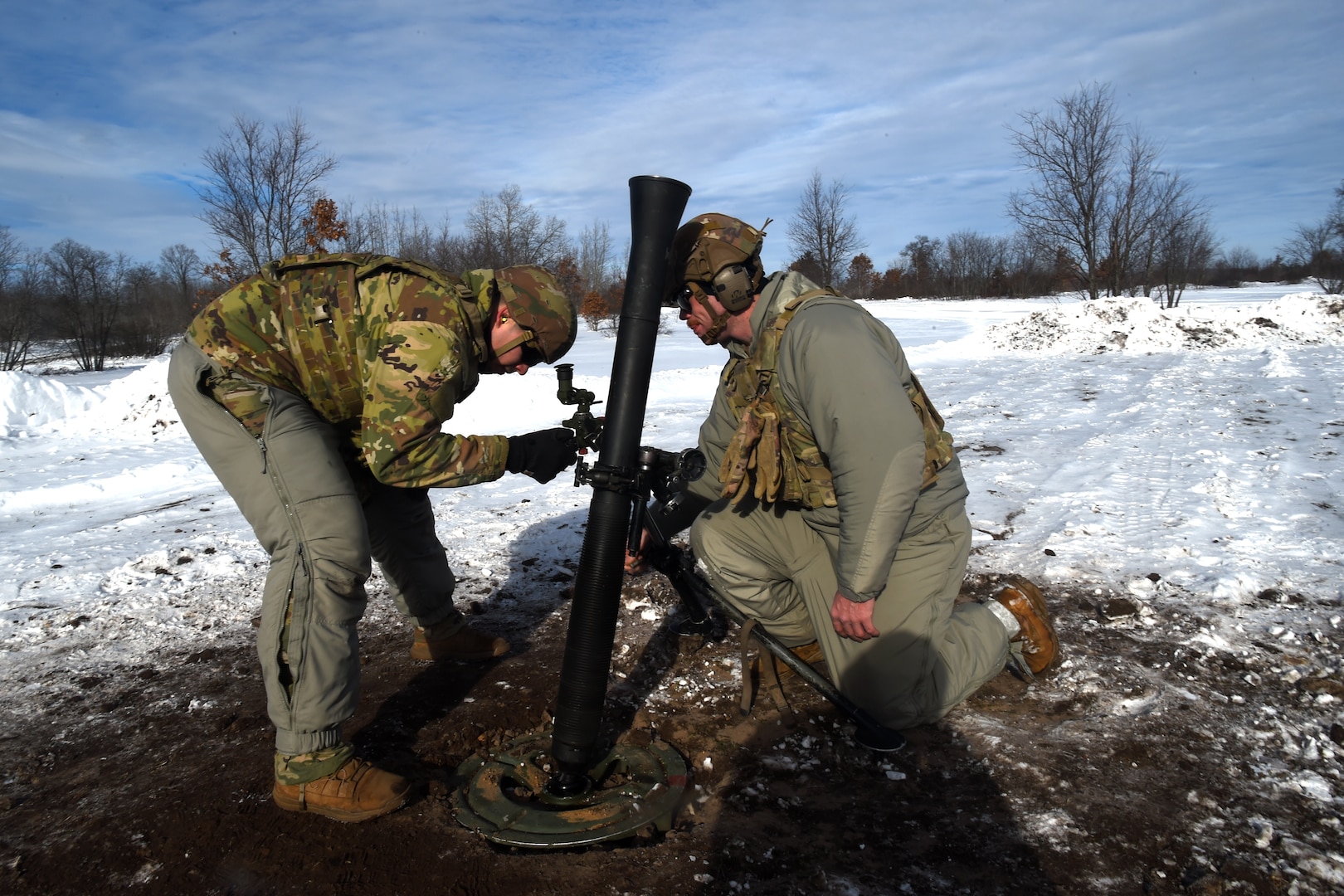 Spc. Emilio Bailey, left, and Spc. Ryan Brust, both indirect fire infantryman with Headquarters and Headquarters Company, 1st Battalion, 125th Infantry Regiment, Michigan Army National Guard, make adjustments to an 81 mm mortar while taking part in exercise Northern Strike 24-1 at Camp Grayling Maneuver Training Center, Michigan, Jan. 21, 2024. Northern Strike 24-1 is the winter warfare component of the annual National Guard Bureau-sponsored Northern Strike exercise series.