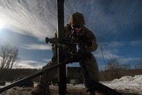 Spc. Emilio Bailey, an indirect fire infantryman with Headquarters and Headquarters Company, 1st Battalion, 125th Infantry Regiment, Michigan Army National Guard, makes adjustments to an 81 mm mortar during exercise Northern Strike 24-1 at Camp Grayling Maneuver Training Center, Michigan, Jan. 21, 2024. Northern Strike 24-1 is the winter warfare component of the annual National Guard Bureau-sponsored Northern Strike exercise series.