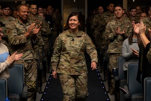 A woman walks down an aisle.