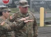 Command Sgt. Maj. Paul Fulmer, the senior enlisted advisor to the Medical Readiness and Training Command's commanding general, listens to Lt. Col. Danielle 