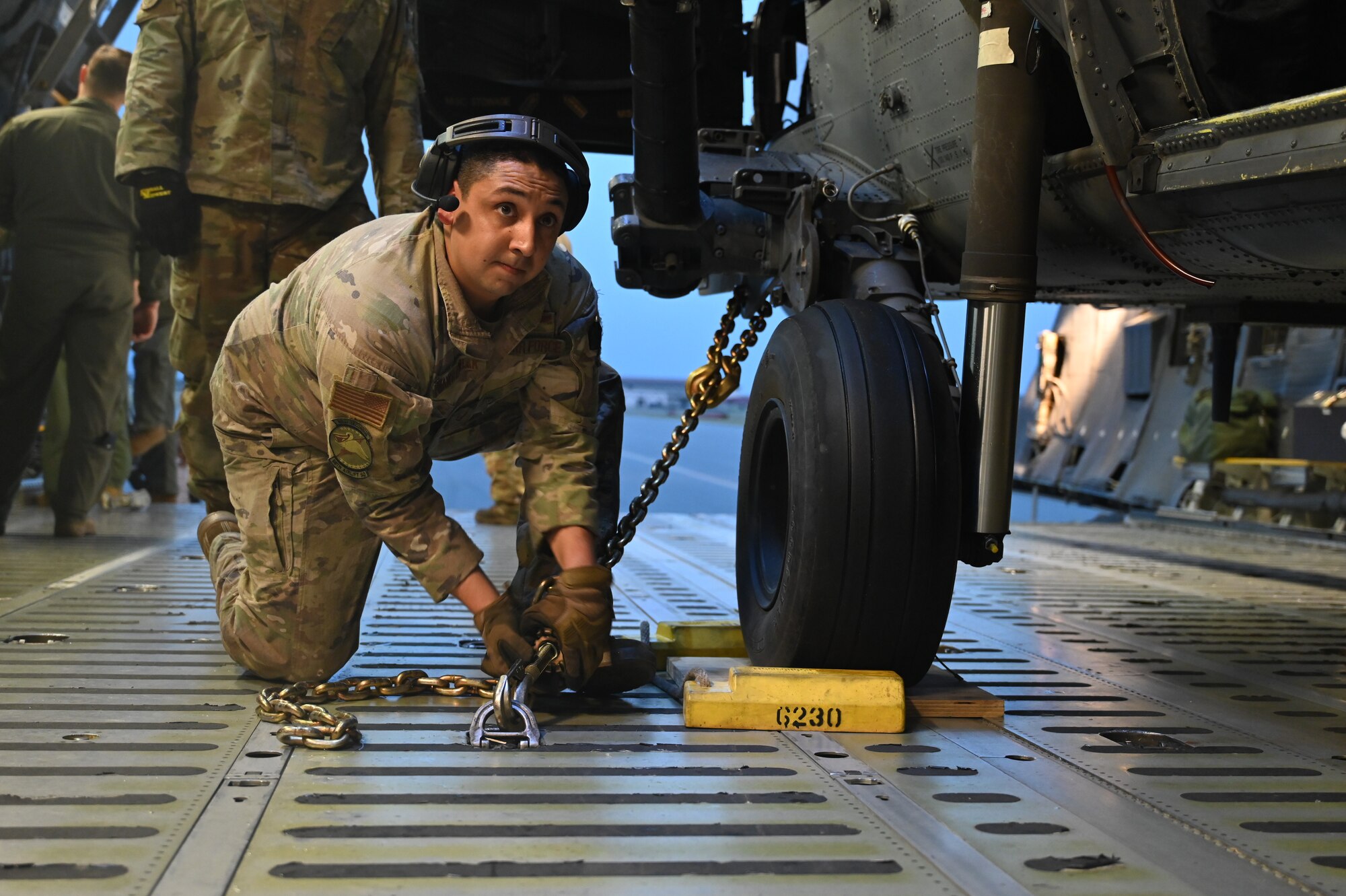 Staff Sgt. Thomas Wawrzyniak, 68th Airlift Squadron loadmaster, helps chain down a HH-60G Pave Hawk from the 920th Rescue Wing onto a C-5M Super Galaxy at Patrick Space Force Base, Florida, Jan. 19, 2024.