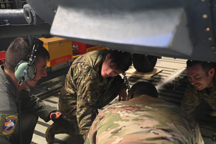 Senior Airman Ethan Krempin, left, 68th Airlift Squadron loadmaster, helps members of the 920th Rescue Wing chain down their HH-60G Pave Hawk at Patrick Space Force Base, Florida, Jan. 19, 2024. Loadmasters follow checklists and review loaded aircraft for maximum safety before departure. (U.S. Air Force photo by Tech. Sgt. Jacob Lewis)