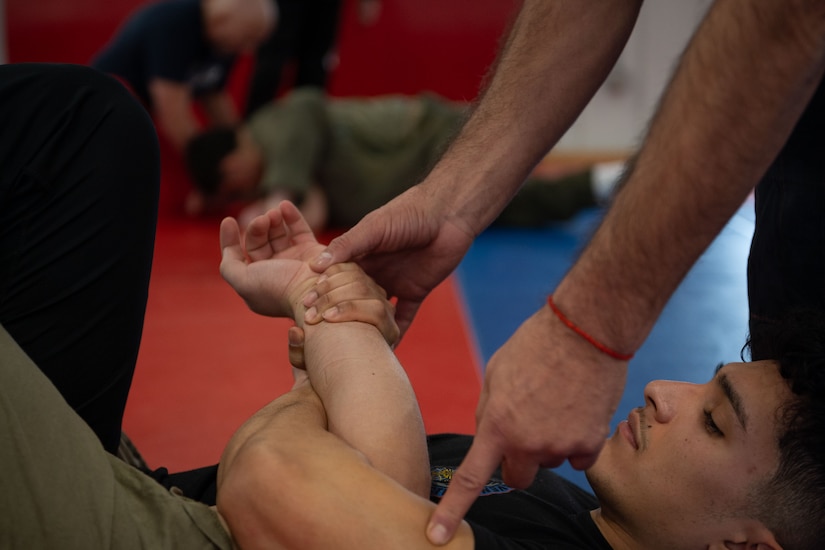 An 87th Security Forces Squadron member performs Brazilian Jiu Jitsu maneuvers during a training course at Joint Base McGuire-Dix-Lakehurst, N.J., Jan. 18, 2024. Master Carlos Machado, a Brazilian Jiu Jitsu instructor, crafted BJJ instruction to expand on the hand-to-hand combat skills crucial to the Security Forces mission, merging BJJ tactics with elements of mindfulness, physical readiness, as well as honing the craft. (U.S. Air Force photo by Staff Sgt. Monica Roybal)
