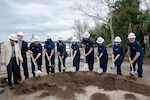 Coast Guard members and designated officials break ground during a Coast Guard groundbreaking ceremony for a new Base Charleston campus in North Charleston, South Carolina, Jan. 26, 2024.