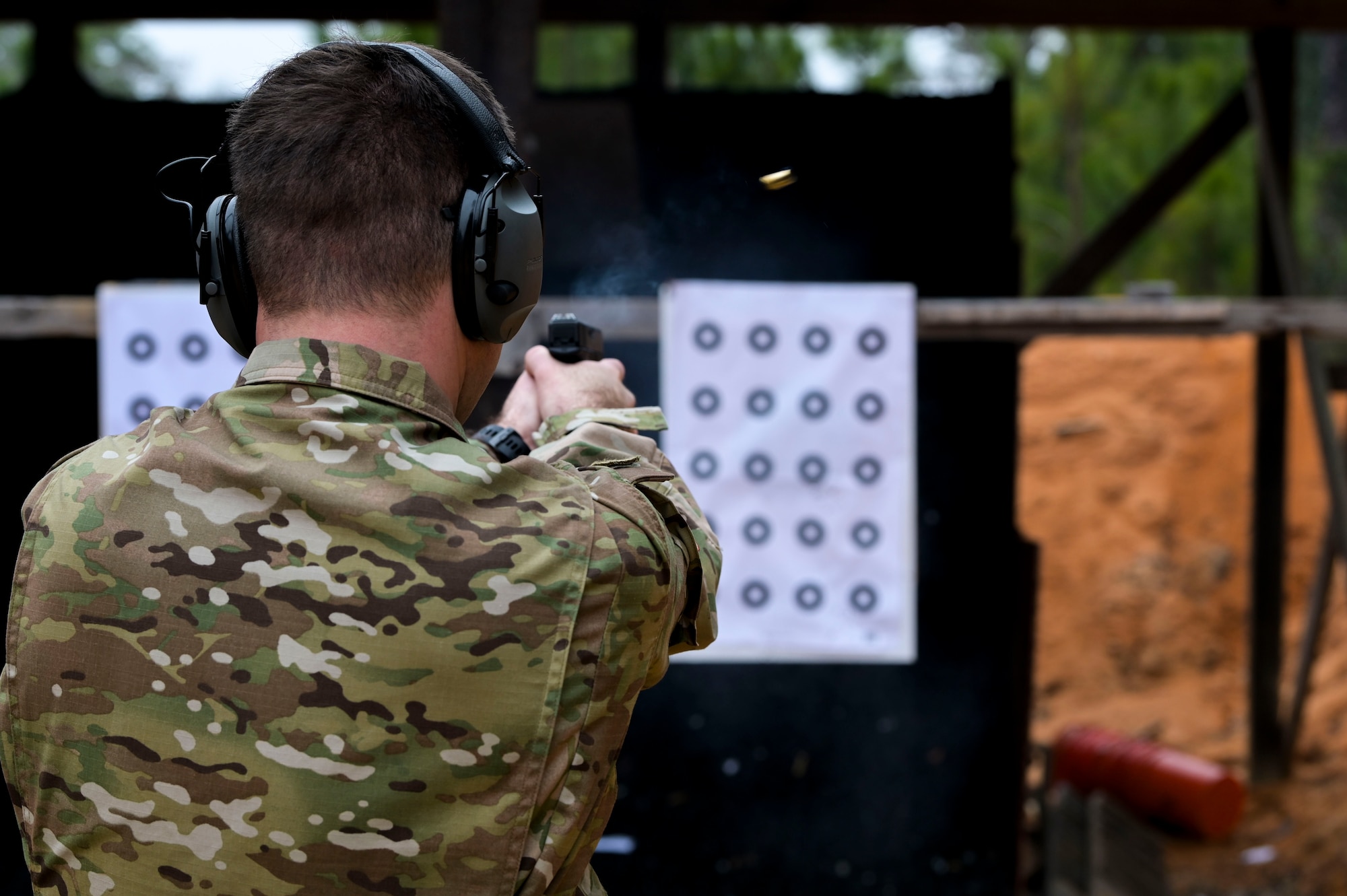 A U.S. Air Force Air Commando shoots a pistol.