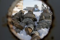 Wisconsin Army National Guard Soldiers with Company A, 2nd Battalion, 127th Infantry Regiment, take up a fighting position approaching the High Risk Entry Facility during urban warfare training Jan. 17, 2024, at Volk Field, Wis. This training event helps prepared Company A for its rotation with the rest of the 32nd Infantry Brigade Combat Team at the Joint Readiness Training Center later this year.