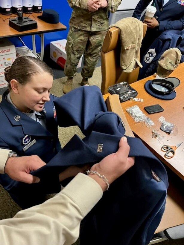 Tech. Sgt. Ericha Guyote, USAF Basic Military Training Instructor, performs uniform triage on the service coat of the 914th Air Refueling Wing commander.