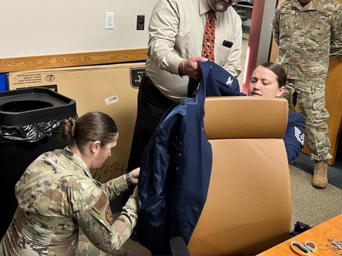 Master Sgt. Jennifer Dowling and Tech. Sgt. Ericha Guyote, USAF Basic Military Training Instructors, performs uniform triage on the service coat of the 914th Air Refueling Wing commander