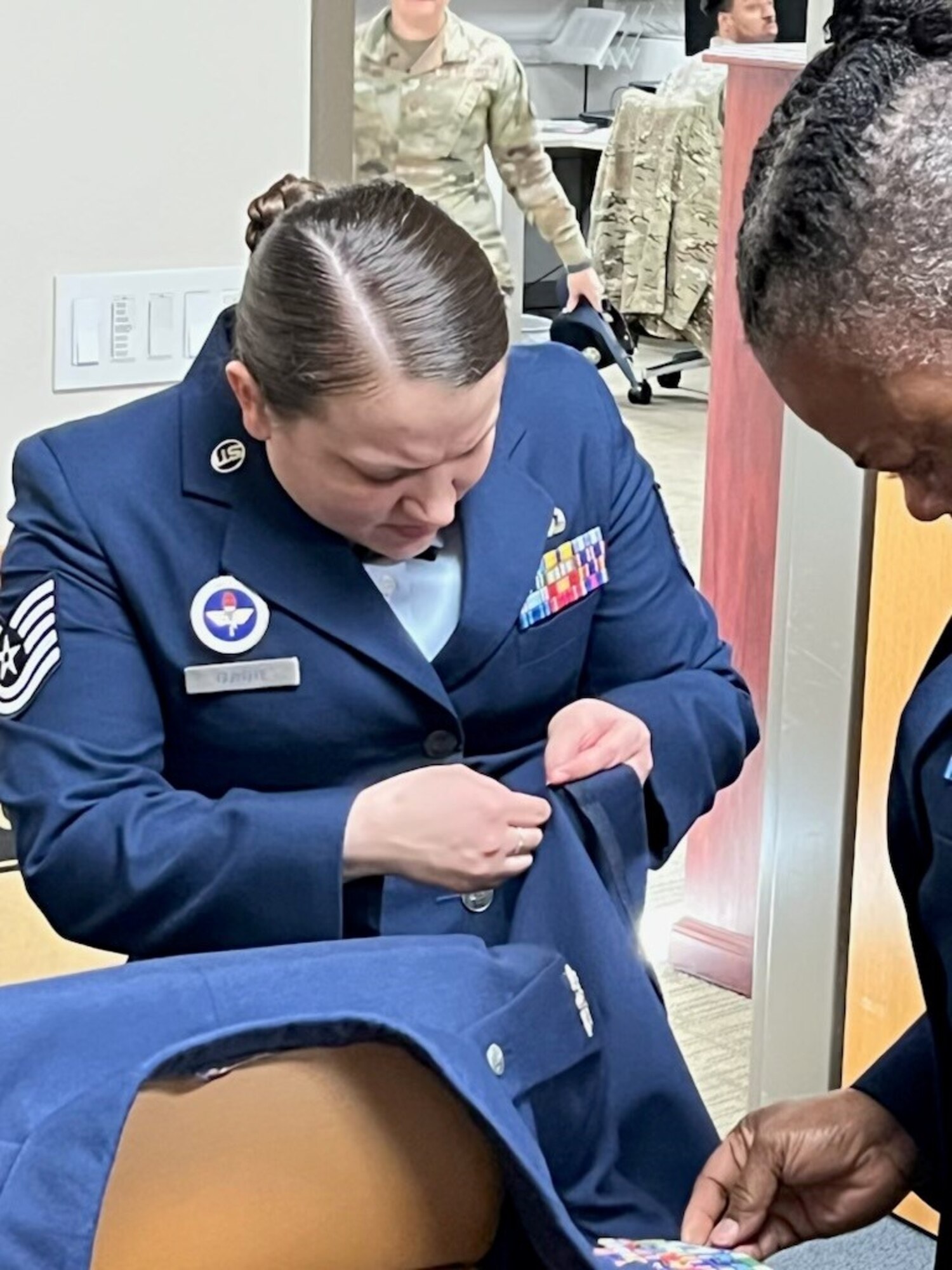 Tech. Sgt. Ericha Guyote, USAF Basic Military Training Instructor, performs uniform triage on the service coat of the 914th Air Refueling Wing commander