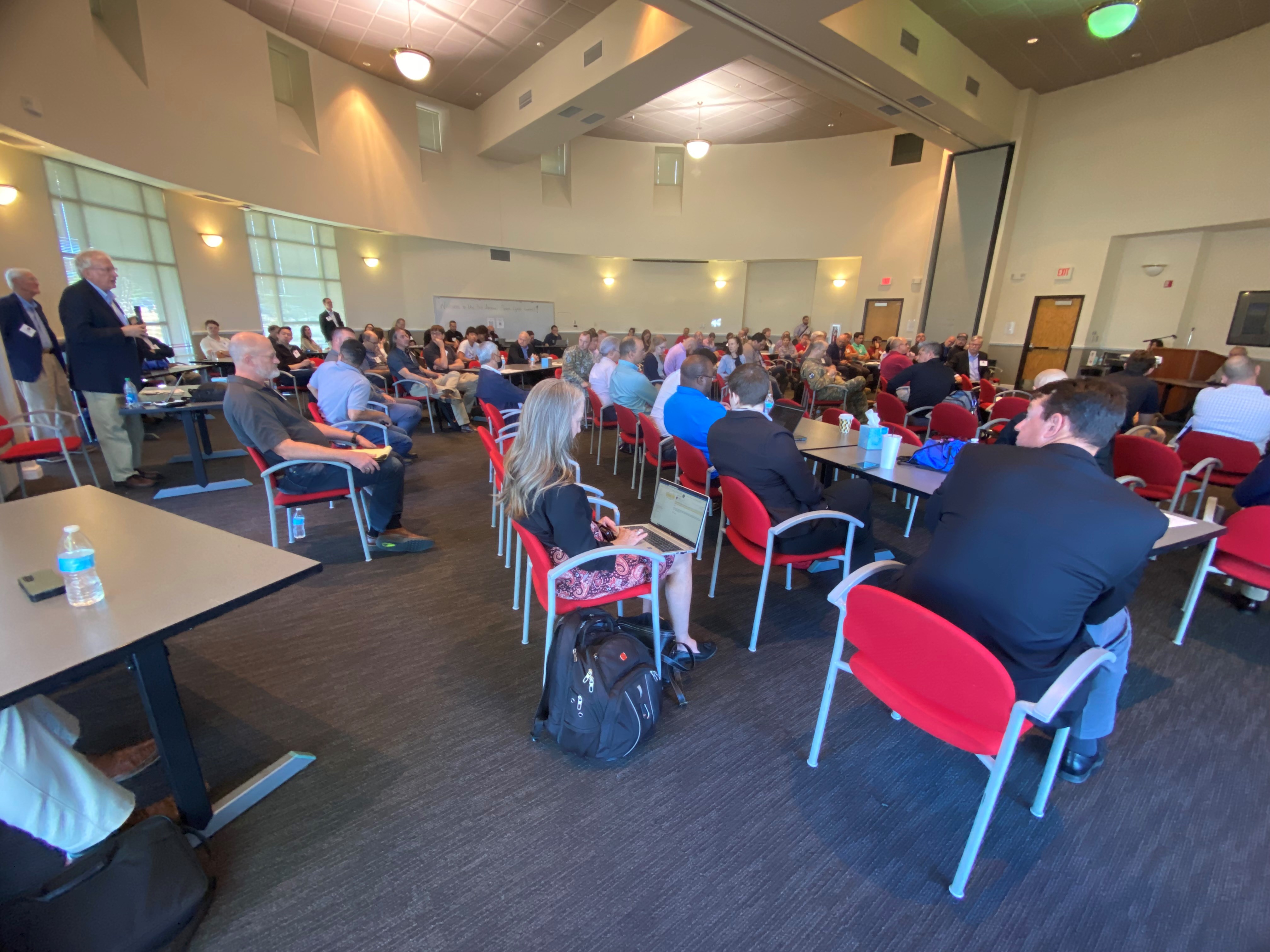 Attendees listen as Joseph “Dan” Trujillo, space cyber resiliency lead, U.S. Air Force Research Lab, Space Vehicle Directorate, speaks during the third annual AFRL Cyber, Space Summit, Oct. 11, 2023, at the Science and Technology Park, University of New Mexico, Rotunda, Albuquerque, N.M. Trujillo provided technical lead for the summit which hosted military and professionals from the Department of Defense, private and commercial industries, the intelligence community and academia. The summit aimed to initiate the expansion of space cyber topics in New Mexico, anticipating technology growth in the coming decades. (U.S. Air Force photo / Jessie Perkins)