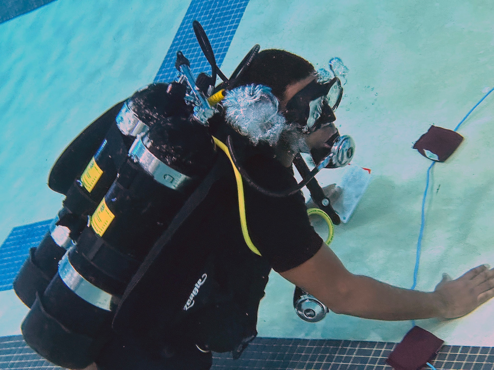 A photo of an Army diver in a swimming pool.