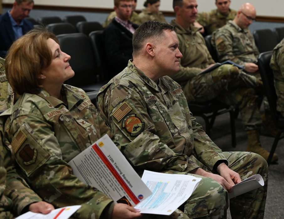 U.S. Air Force Brig. Gen. William Kale, Air Force Civil Engineer Center commander, and Col. Angelina Maguiness, 17th Training Wing commander, listen to the 312th Training Squadron brief during Kale’s visit at the Louis F. Garland Department of Defense Fire Academy, Goodfellow Air Force Base, Texas, Jan. 18, 2024. The Louis F. Garland DoD Fire Academy is the largest fire training facility in the world and graduates over 1,400 joint service students each year. (U.S. Air Force photo by Airman 1st Class Evelyn D’Errico)