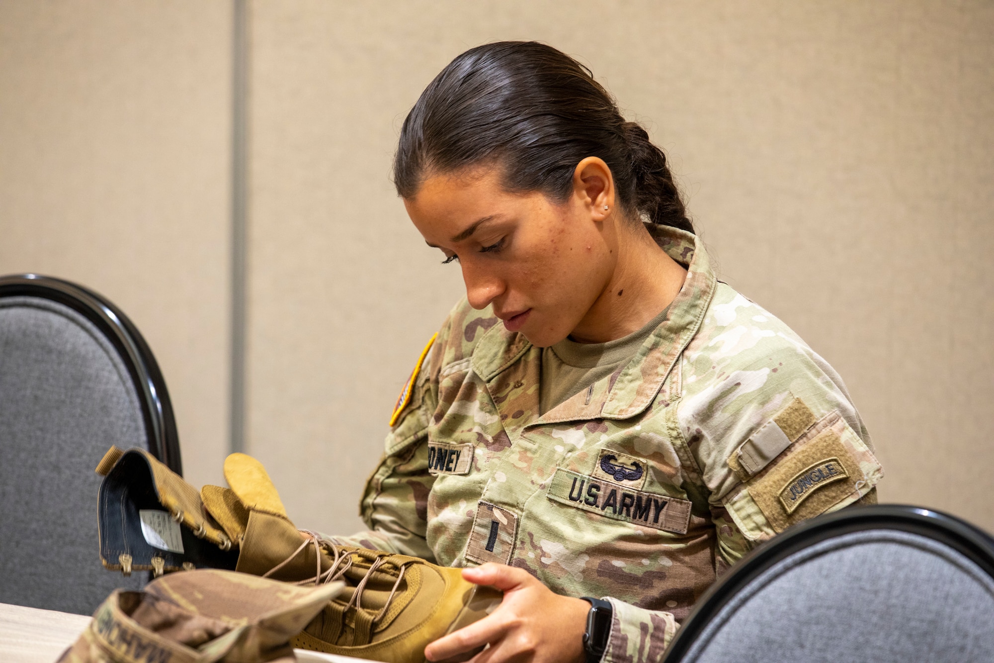 U.S. Army 1st Lt. Claudia Mahoney, a field artillery officer assigned to 3rd Battalion, 7th Field Artillery Regiment, 25th Division Artillery Brigade, 25th Infantry Division, examines a Marine Corps tropical combat boot during a Jungle Environment Leadership Working Group, Jan. 22, 2024, Honolulu, Hawaii. The working group was held for jungle-affiliated military leaders to speak about establishing a priority list of material modernization efforts and acquisition strategies for Organizational Clothing and Individual Equipment (OCIE) and protection specific to the jungle environment. (U.S. Army photo by Sgt. Alvin Conley, 25th Infantry Division)