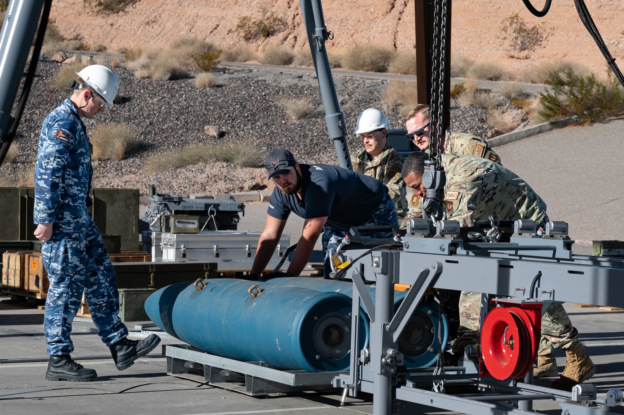 US and Royal Australian Air Force Airmen building GBU munitions.