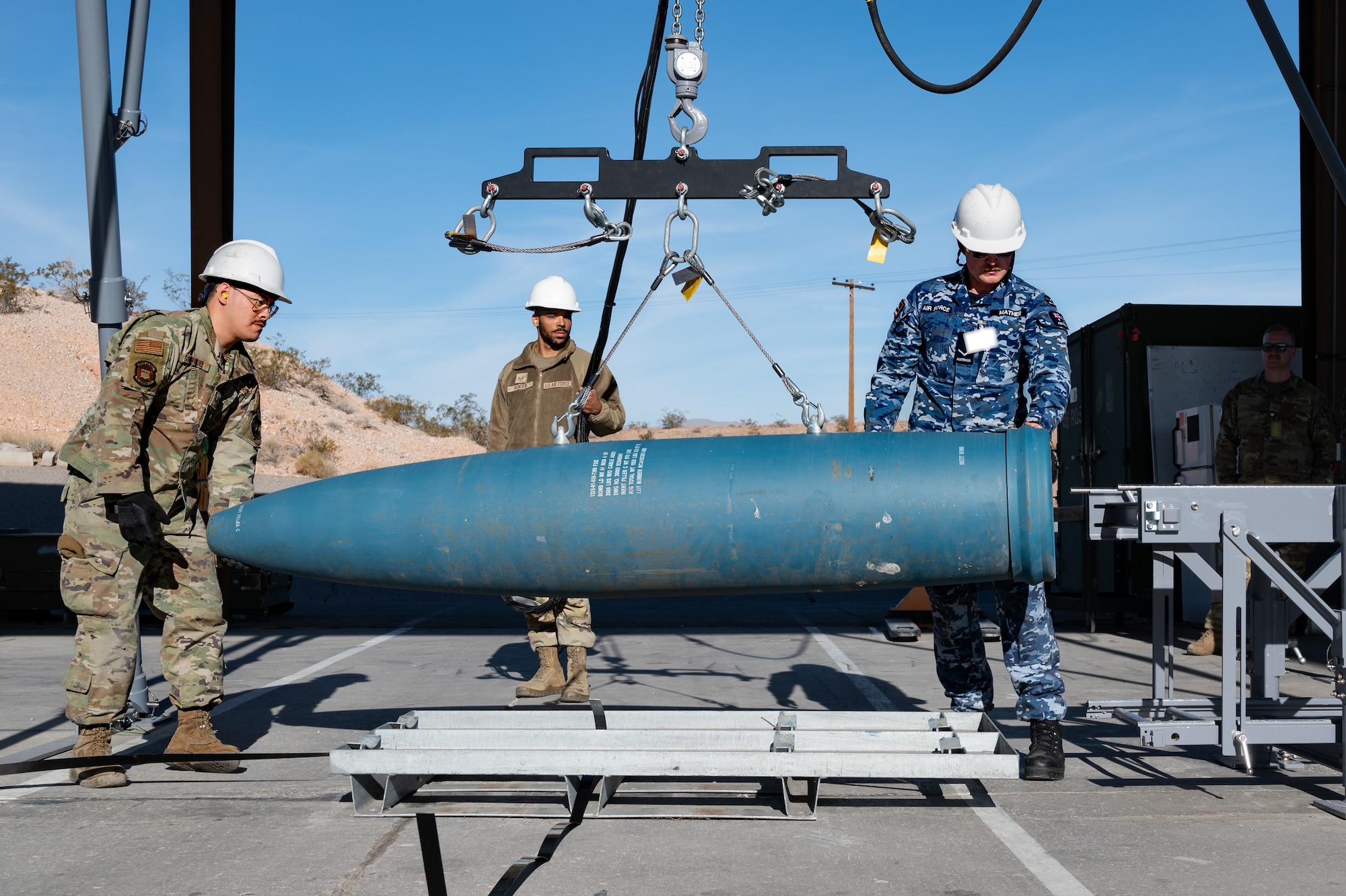 US and Royal Australian Air Force Airmen building GBU munitions.