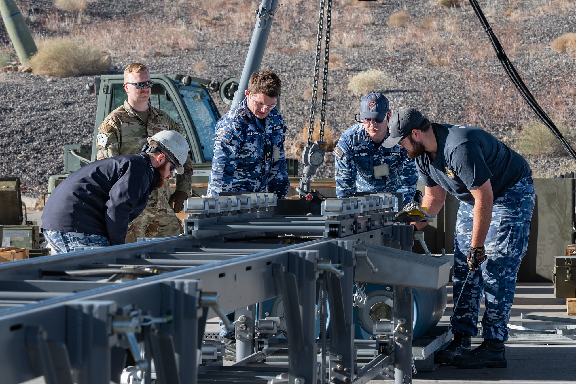 US and Royal Australian Air Force Airmen building GBU munitions.