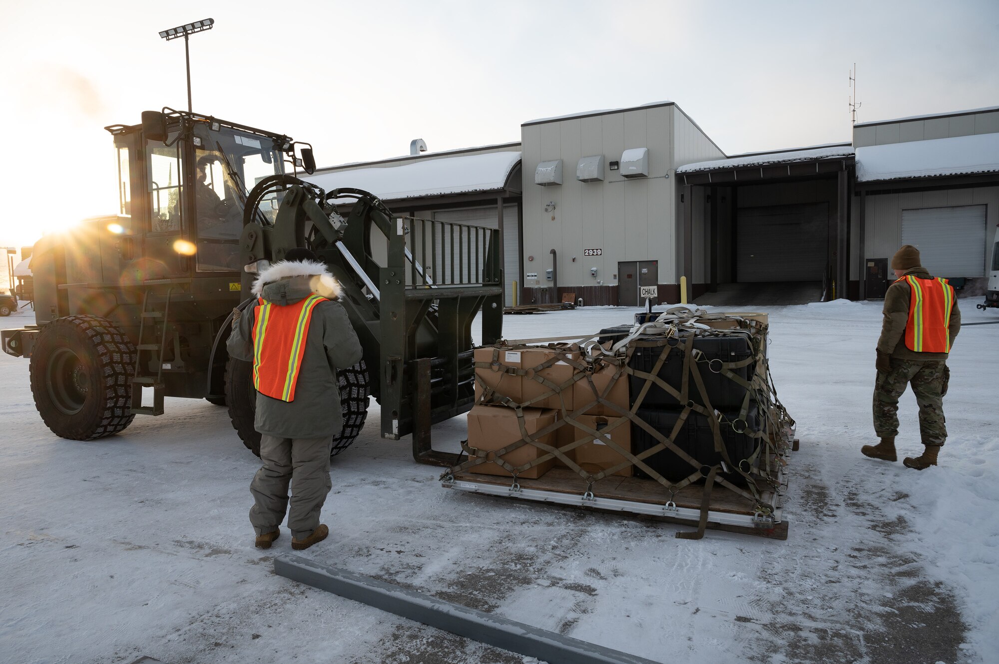 A forklift crew from the 354th Logistics Readiness Squadron unloads a pallet of equipment for exercise Arctic Gold 24-1, on Eielson Air Force Base, Alaska, Jan 24, 2024. Exercise Arctic Gold 24-1 helped prepare airmen for a real-life deployment and hone their skills within their career field. (U.S. Air Force photo by Airman Spencer Hanson)