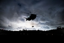 A U.S. Marine Corps CH-53E Super Stallion assigned to Marine Heavy Helicopter Squadron 466, 1st Marine Aircraft Wing, lifts a pallet during helicopter support team training at Landing Zone Dodo, Camp Hansen, Okinawa, Japan, Jan. 25, 2024. The training rehearsed sustaining the ground combat element within an Alert Contingency Marine Air-Ground Task Force, and enhanced the Marines' ability to conduct expeditious transport and versatility in support of expeditionary advanced base operations.