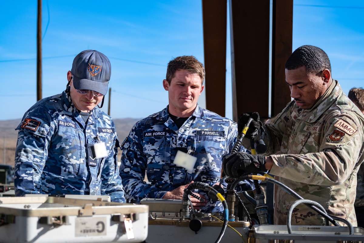 US and Royal Australian Air Force Airmen building GBU munitions.