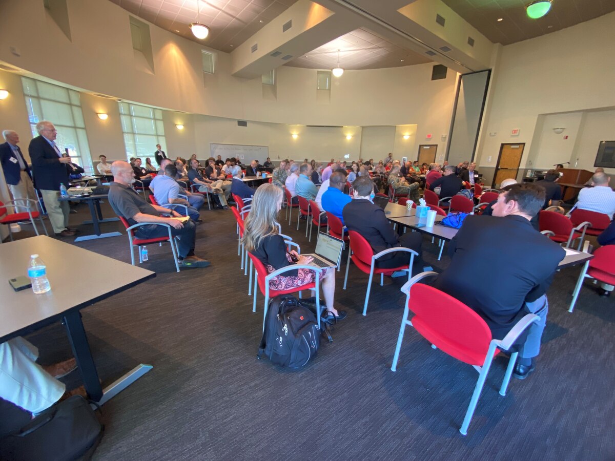 Attendees listen as Joseph “Dan” Trujillo, space cyber resiliency lead, U.S. Air Force Research Lab, Space Vehicle Directorate, speaks during the third annual AFRL Cyber, Space Summit, Oct. 11, 2023, at the Science and Technology Park, University of New Mexico, Rotunda, Albuquerque, N.M. Trujillo provided technical lead for the summit which hosted military and professionals from the Department of Defense, private and commercial industries, the intelligence community and academia. The summit aimed to initiate the expansion of space cyber topics in New Mexico, anticipating technology growth in the coming decades. (U.S. Air Force photo / Jessie Perkins)