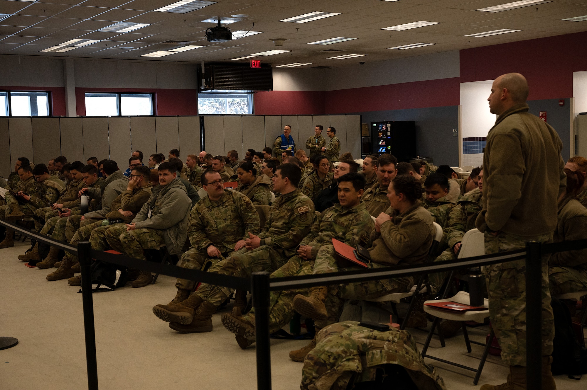 Members from the 354th Fighter Wing wait in a conference room to receive direction during exercise Arctic Gold 24-1, on Eielson Air Force Base, Alaska, Jan 24. 2024. Exercise Arctic Gold helped prepare Airmen for a real-life deployment and hone their skills within their career field. (U.S. Air Force photo by Airman Spencer Hanson)