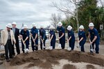 Coast Guard members and designated officials break ground during a Coast Guard groundbreaking ceremony for a new Base Charleston campus in North Charleston, South Carolina, Jan. 26, 2024.