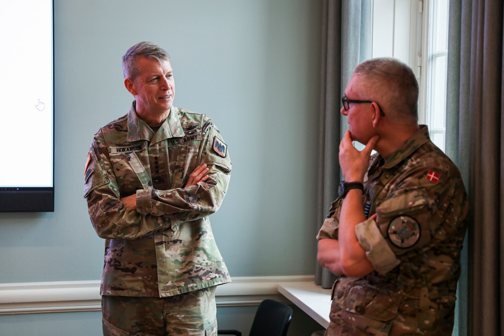 Army Gen. Daniel Hokanson, chief of the National Guard Bureau, left, talks with Gen. Flemming Lentfer, the Danish Chief of Defense, at the Ministry of Defense, Copenhagen, Denmark, Jan. 23, 2024.