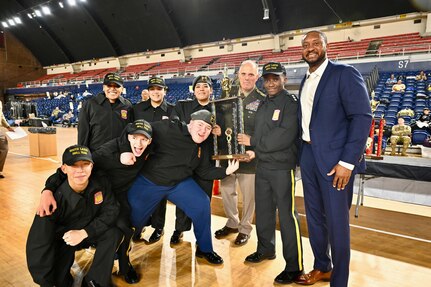 Brig. Gen. Leland D. Blanchard II, commander, District of Columbia National Guard Land Component Command (LCC), and Marcus L. Hunt, Director of the District of Columbia Operations, D.C. National Guard, present a trophy to winners of the 2024 JROTC “Best of the Best” Drill Competition at the D.C. Armory, Jan. 27, 2024. The regional qualifier is a collaboration between D.C. Public Schools, D.C. Government Operations, and the D.C. National Guard.