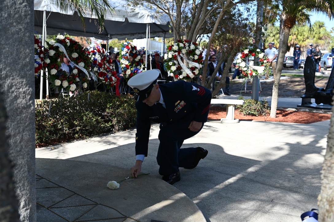 A Coast Guard petty officer lays a rose at the memorial of the CGC Blackthorn, Jan. 28, 2024, St. Petersburg, Florida. 23 roses were laid here in honor of the 23 crew members who perished along with the Blackthorn on January 28, 1980. (U.S. Coast Guard photo by Petty Officer 3rd Class Nicholas Strasburg)