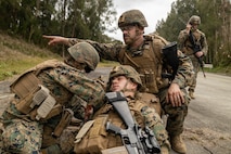 U.S. Marines with 3rd Maintenance Battalion, 3rd Sustainment Group (Experimental), 3rd Marine Logistics Group, provide aid to a simulated casualty during an Intermediate Maintenance Activity Field Exercise on Camp Hansen, Okinawa, Japan, Jan. 25, 2024. 3rd Maint. Bn. held a FEX to enhance Marine Corps common skills and foster force readiness while conducting higher echelons of maintenance. (U.S. Marine Corps photo by Lance Cpl. Federico Marquez)