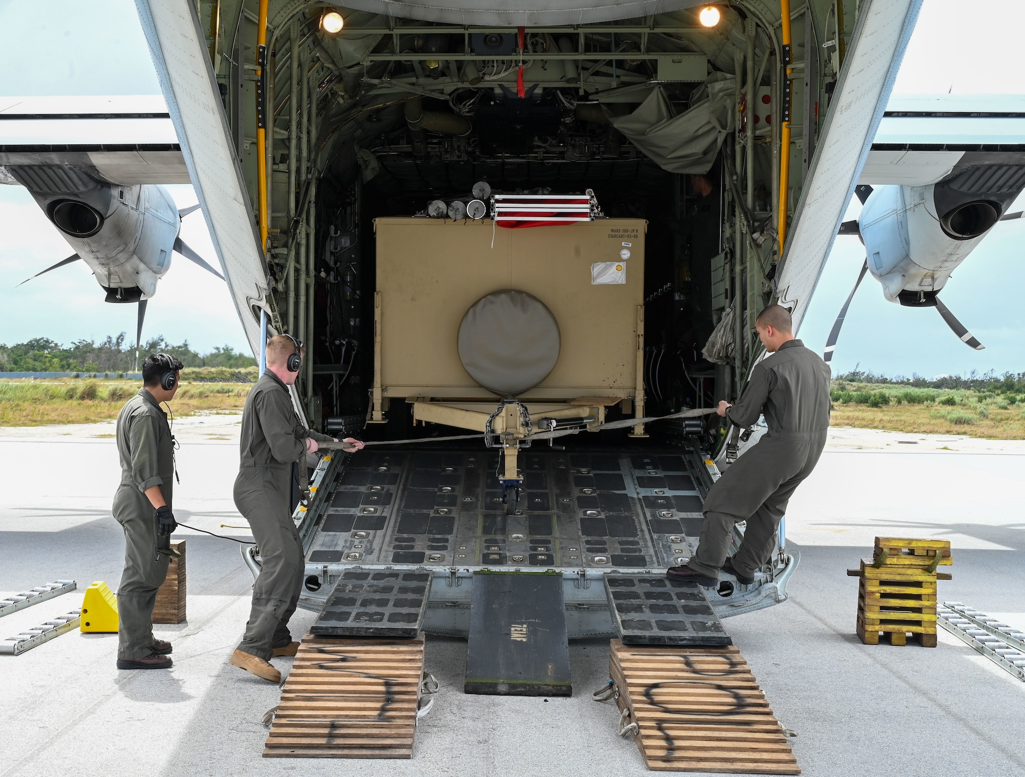 U.S. Marines assigned to Marine Aerial Refueler Transport Squadron (VMGR-234), Fort Worth, Texas, offload a STARCART in preparation for Aerial Delivered Ground Refueling (ADGR) training at the Pacific Regional Training Center-Andersen, Guam, Jan. 22, 2024. The Marine Corps, Air Force and Navy trained together on using two different refueling systems: a STARCART and a Helicopter Expedient Refueling System (HERS). (U.S. Air Force photo by Airman 1st Class Natasha Ninete).