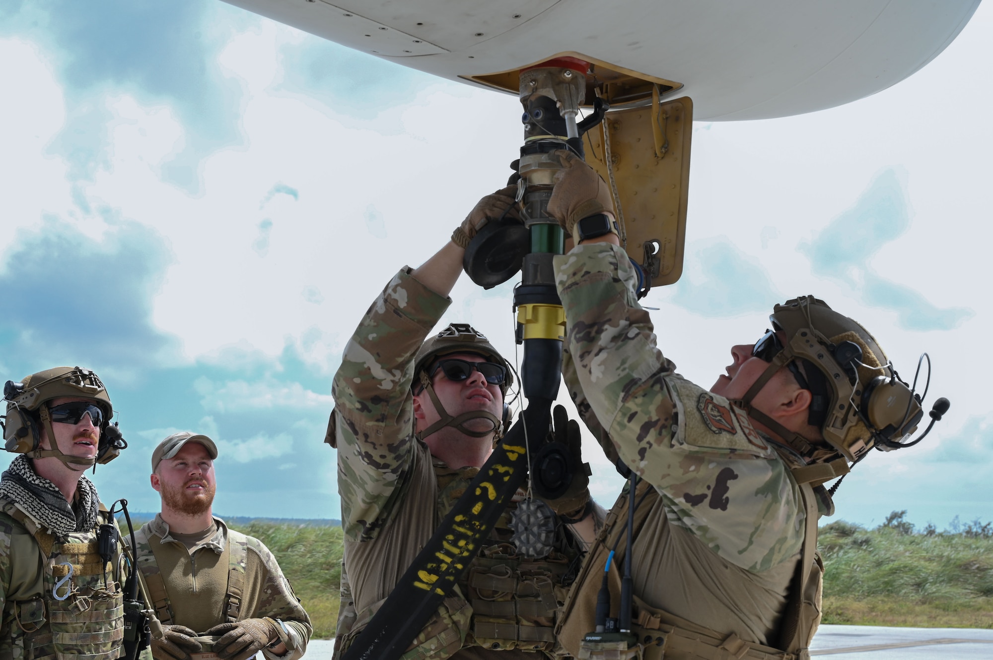 U.S. Airmen assigned to 36 Contingency Response Squadron (CRS) attach a fuel hose to a KC-130J at the Pacific Regional Training Center-Andersen, Guam, Jan. 22, 2024. The aircraft, assigned to the Marine Aerial Refueler Transport Squadron (VMGR 234) from Fort Worth, Texas, was used in training to qualify Marines and Airmen on refueling and defueling operations. (U.S. Air Force photo by Airman 1st Class Natasha Ninete).