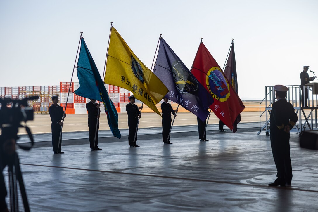 Japan Maritime Self-Defense Force members with Fleet Air Wing 31 present unit flags during the New Year’s first flight ceremony at Marine Corps Air Station Iwakuni, Japan, Jan. 5, 2024. The JMSDF New Year’s flight is typically held at the beginning of January, and this year’s flight showcased the US-2’s capabilities, as well as Fleet Air Wing 31’s ability to swiftly and successfully conduct search and rescue missions. This is the first time in 9 years the event has been held at Iwakuni. (U.S. Marine Corps photo by Cpl. Calah Thompson)