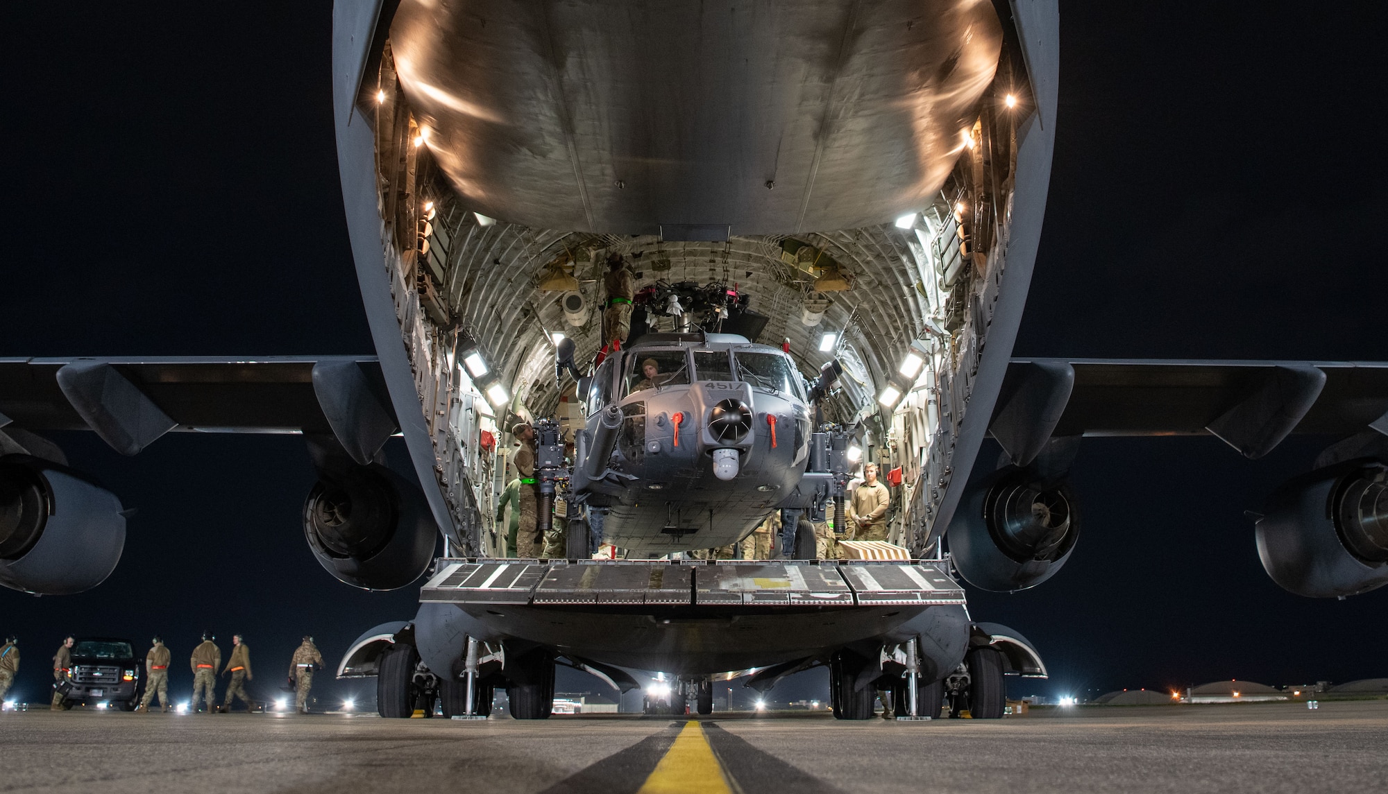 An HH-60W sits inside of a C-17.