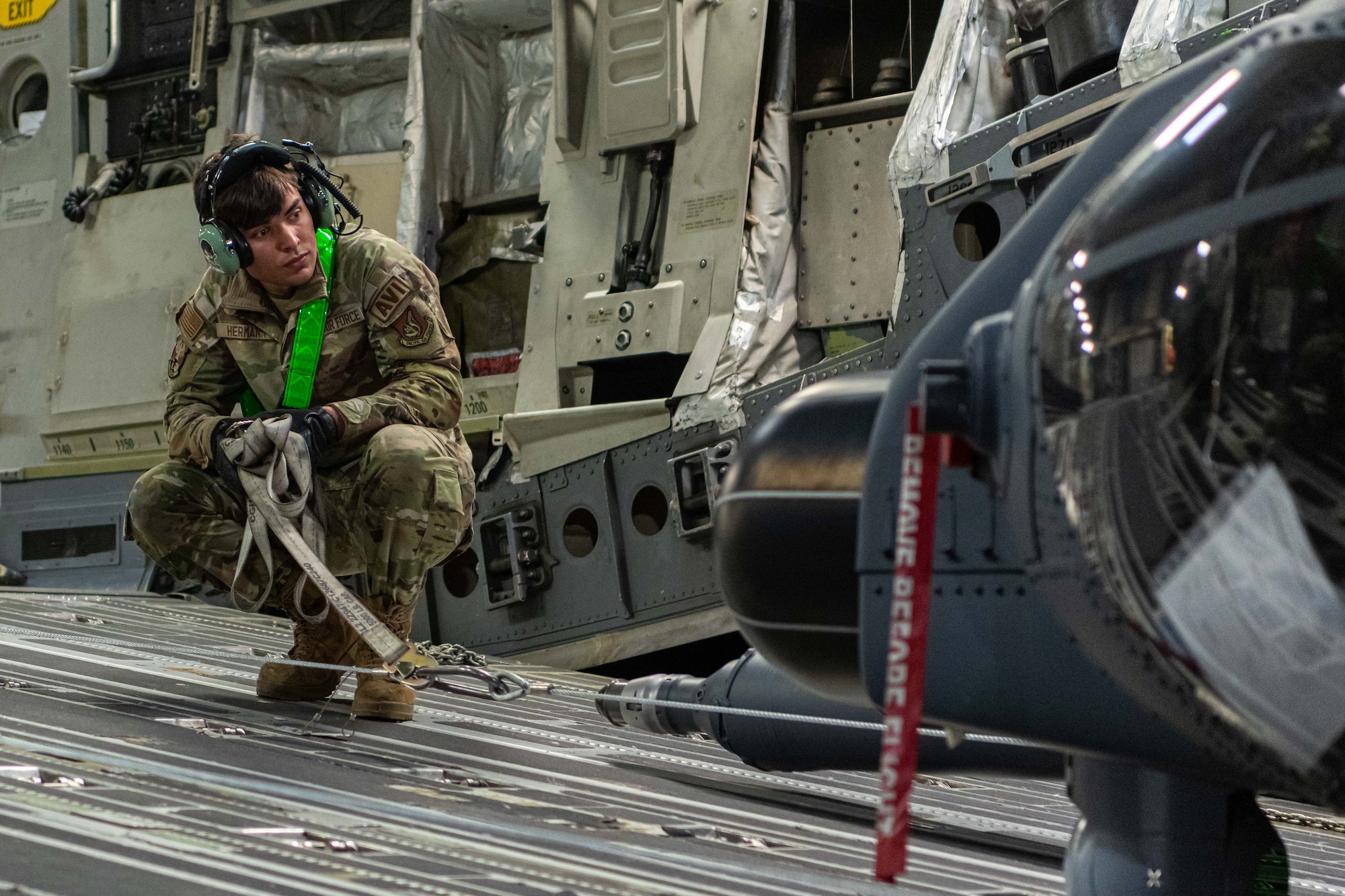 An HH-60 avionics apprentice conducts offloading operations.