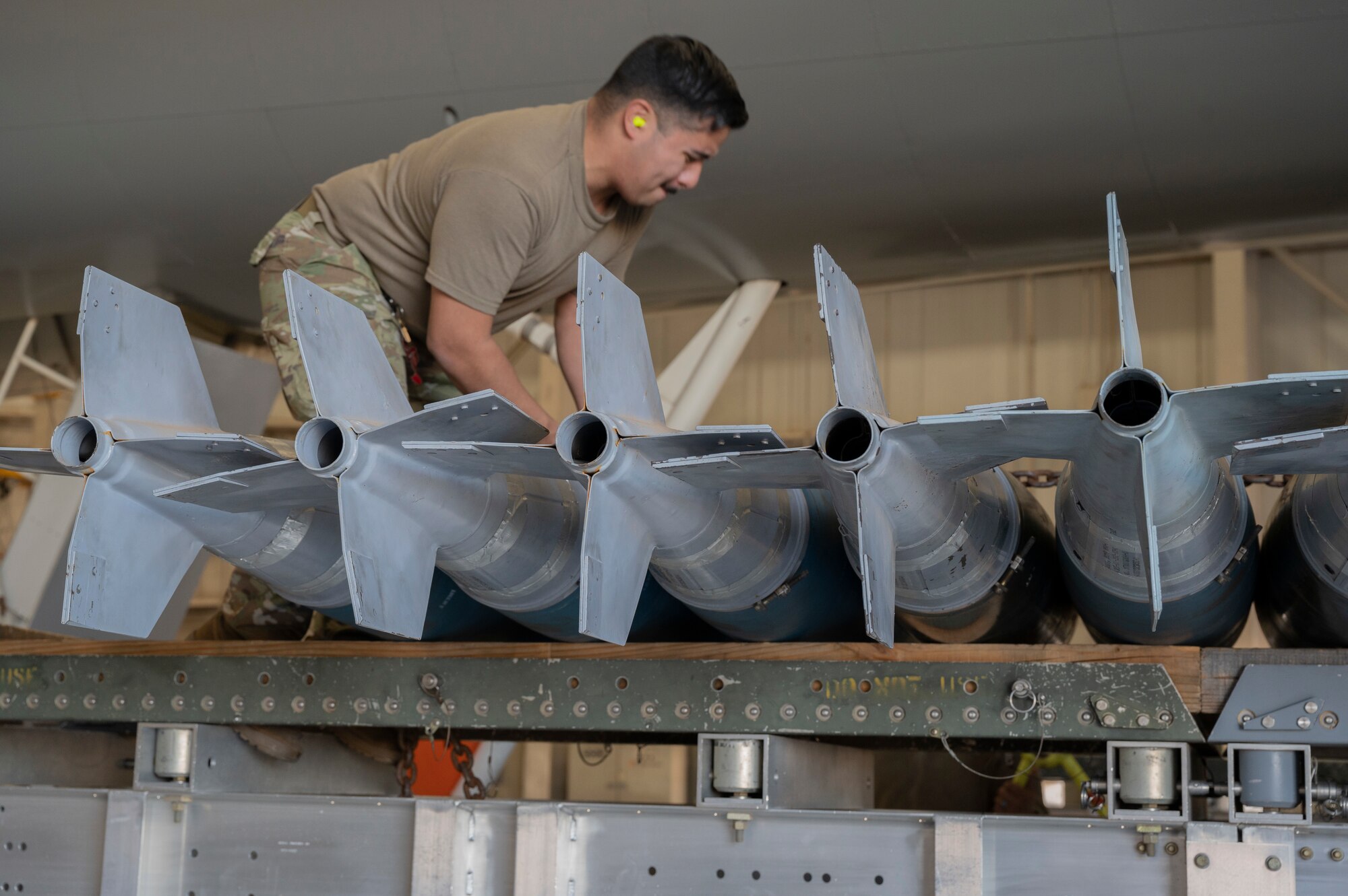 U.S. Air Force Senior Airman Ansorena, 7th Aircraft Maintenance Squadron weapons load crew technician, competes in a load crew competition at Dyess Air Force Base, Texas, Jan. 10, 2024. Quarterly load competitions proved which team could load their training bombs the best based on quality and time. (U.S. Air Force photo by Airman 1st Class Alondra Cristobal Hernandez)