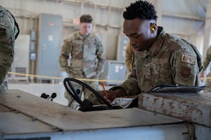 U.S. Air Force Airman 1st Class Tayveon Johnson, 7th Aircraft Maintenance Squadron weapons load crew technician, competes in the annual load crew competition at Dyess Air Force Base, Texas, Jan. 10, 2024. The competition simulates a deployed environment where load crews demonstrate speed and efficiency in loading aircraft. (U.S. Air Force photo by Airman 1st Class Alondra Cristobal Hernandez)