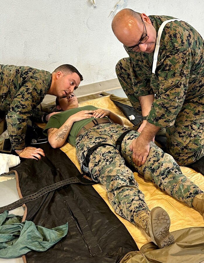 U.S. Navy Hospital Corpsman Petty Officer 1st Class Jorge Velasquez, 23D Marine Regiment, 4th Marine Division, Marine Forces Reserve, preforms a “blood sweep” on patient Sgt. Marissa Escobedo as Chief Calderin-Serrano monitors her breathing for the Valkyrie whole blood transfusion program in San Bruno, CA on Jan. 10, 2024. The Valkyrie Program is a course designed to teach attendees how and when to apply a whole blood transfusion to casualties in a combat environment. (Courtesy Photo)