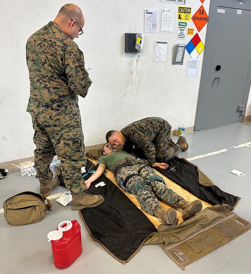 U.S. Navy Hospital Corpsman Petty Officer 1st Class Jorge Velasquez, 23D Marine Regiment, 4th Marine Division, Marine Forces Reserve, documents vital signs on patient, Sgt. Marissa Escobedo, as Chief Calderin-Serrano evaluates her breathing for the Valkyrie whole blood transfusion program in San Bruno, CA on Jan. 10, 2024. The Valkyrie Program is a course designed to teach attendees how and when to apply a whole blood transfusion to casualties in a combat environment. (Courtesy Photo)