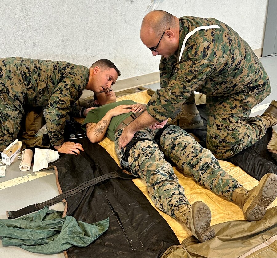 U.S. Navy Hospital Corpsman Petty Officer 1st Class Jorge Velasquez, 23D Marine Regiment, 4th Marine Division, Marine Forces Reserve, preforms a “blood sweep” on patient Sgt. Marissa Escobedo as Chief Calderin-Serrano monitors her breathing for the Valkyrie whole blood transfusion program in San Bruno, CA on Jan. 10, 2024. The Valkyrie Program is a course designed to teach attendees how and when to apply a whole blood transfusion to casualties in a combat environment. (Courtesy Photo)