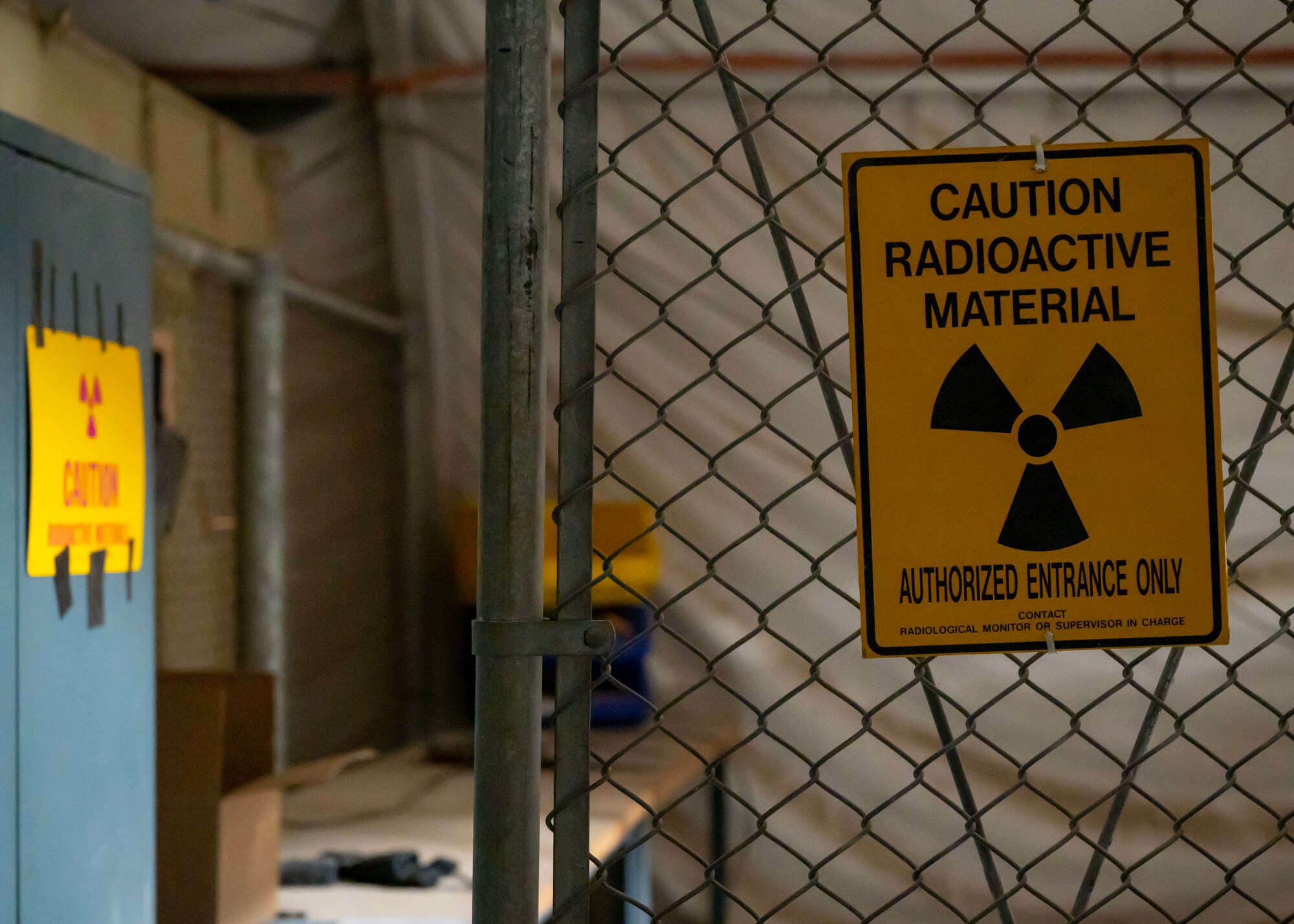 A hazard sign hangs on a fence at an undisclosed location in the U.S. Central Command area of responsibility, Jan. 22, 2024. Exercise Desert Dragon implemented an Air Combat Employment mindset that empowered Airmen to cultivate innovation and think creatively, fostering a shift from stationary installations to a more dynamic approach, allowing Airmen to deploy across a broader geographical area for future challenges. (U.S. Air Force photo by Senior Airman Sarah Williams)