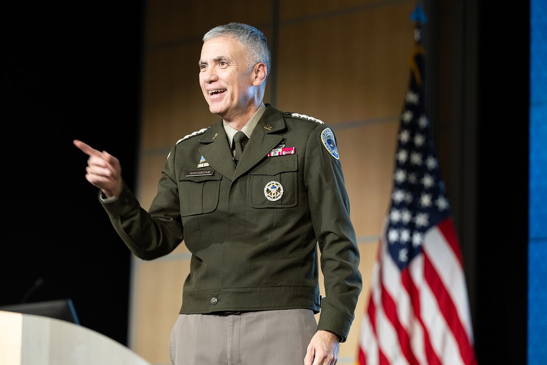 General Nakasone jokes with the workforce during a Town Hall event