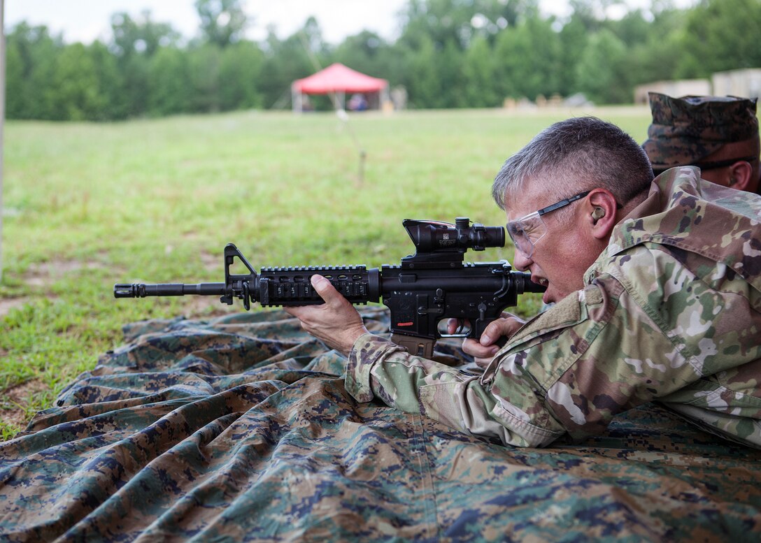 General Nakasone aims down range, during a training exercise, keeping his skills sharp.